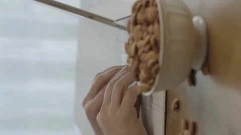 A freelance man drinks coffee, eats roasted almonds Stock Footage 204711315