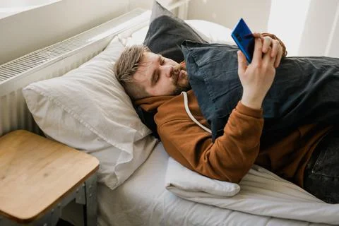 Freelance man using mobile phone checking social media network feed or message Foto stock