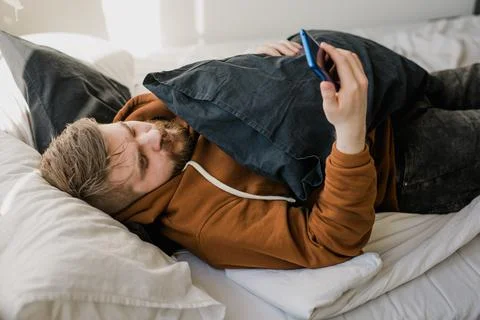 Freelance man using mobile phone checking social media network feed or message Stock Photos