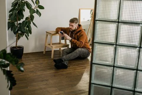 Freelance man using mobile phone checking social media network feed or message 写真素材