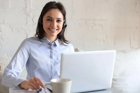 Freelance operator talking with headsets and consulting clients. Stock Photos