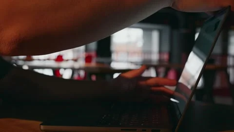 A freelance programmer came to work in a cafe and opens a laptop Stock Footage 258970146
