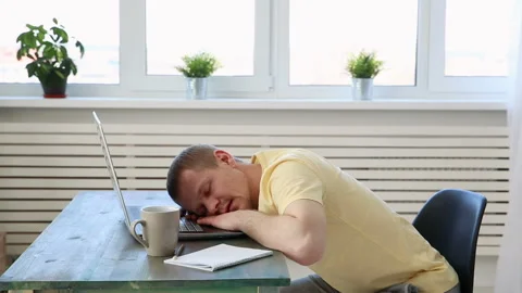 Freelance programmer falls asleep from fatigue at his desk with a laptop Stock Footage 91262268