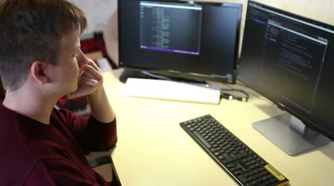 Freelance programmer writes a program while sitting at the computer Vidéo 63421288