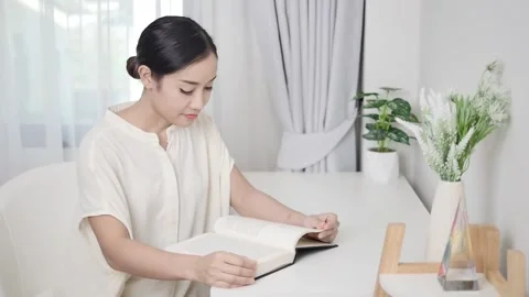A freelance translator using a laptop sits on a kitchen table in self-quarantine Stock Footage 196910079