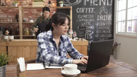 Freelance typing on laptop working in cafe Video stock 108668572