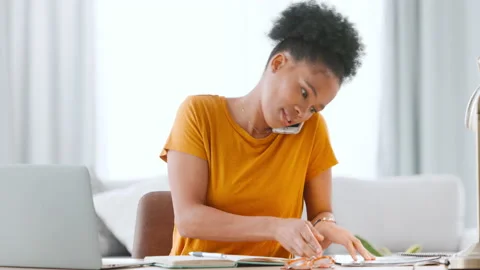 Freelance web developer rushing while speaking to a client, looking through Stock Footage 201906399