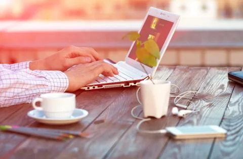 Freelance work at wood Table located on outdoor terrace Stock Photos