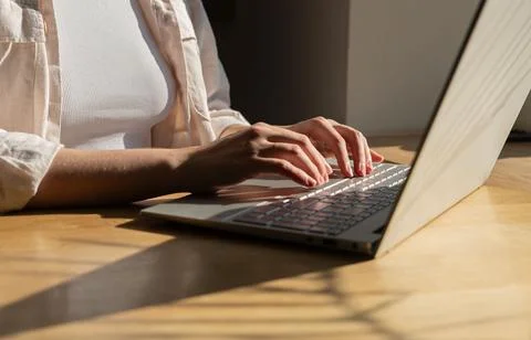 Freelance worker working at laptop computer on wood table, desk, sunny day,.. Stock Photos