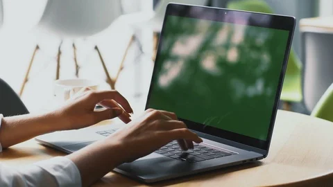 Freelancer arms typing on chromakey screen of personal computer in modern cafe Stock Footage 117127004