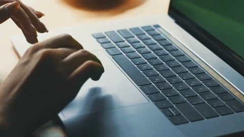 Freelancer arms using touchpad on laptop with chromakey Stock Footage 117128096