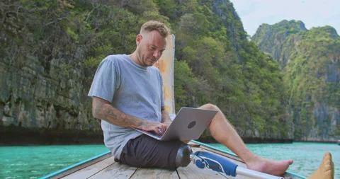 Freelancer with artificial bionic leg remote working to office on vacation. Stock Footage 195003130