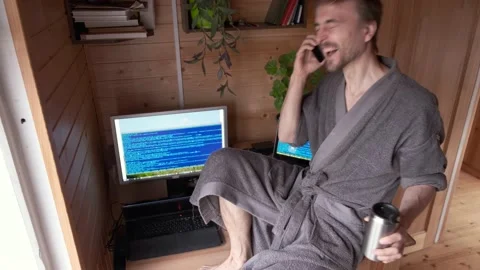 Freelancer in bathrobe work from home in quarantine workplace, smile and fun Видео 130493620