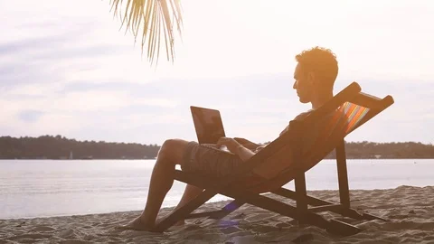 Freelancer on the beach working on computer Stock Footage 98092900