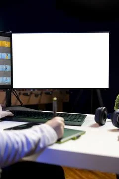 Freelancer browsing images on mockup PC in media agency Stock Photos