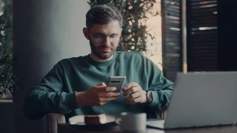 Freelancer In Cafe, Portrait Of Young Man Using Smartphone For Rest After Stock Footage 343411085
