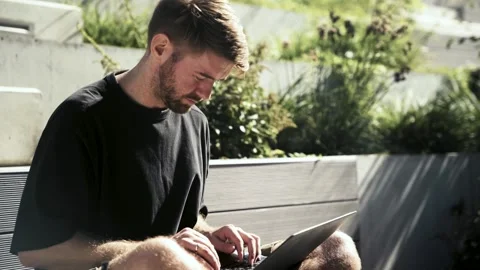 Freelancer calm man typing on laptop at remote workplace outdoor, greenery. Stock Footage 316131454