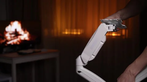 Freelancer carefully assembling white dual monitor bracket, ensuring secure and Stock Footage 297631241