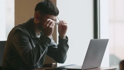 A freelancer comes up with an idea to solve a work problem. The young guy with Stock-Footage 235783908