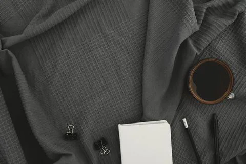 Freelancer concept with copy space. Coffee mug with diary and pen on gray pla Stock Photos