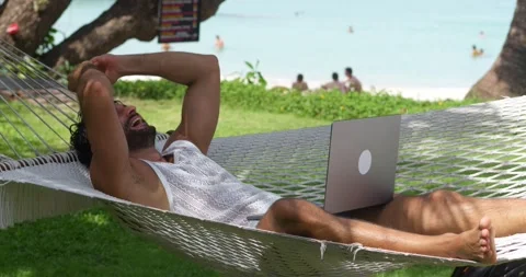 Freelancer developer programmer on vacations, chilling in the camping hammock Stock Footage 220597386