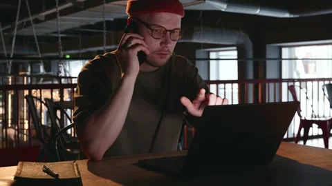 A freelancer discusses his work with his boss over the phone. Stock Footage 258137855