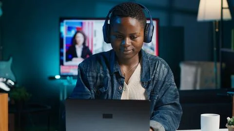Freelancer doing computer tasks while listening music Foto stock
