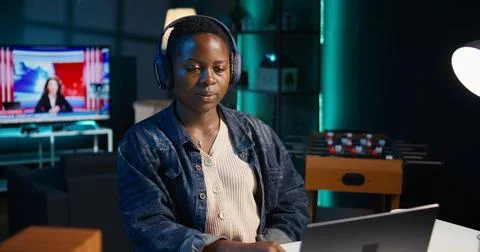 Freelancer doing computer tasks while listening music Foto stock