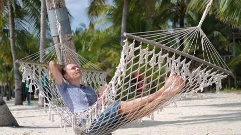 Freelancer enjoys work and relaxation on a beach Stock Footage 312381753