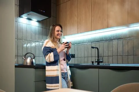 Freelancer evening routine with warm drink in modern kitchen Stock Photos