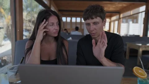 Freelancer explaining work to female client during consultation, discussing Stock Footage 346243005