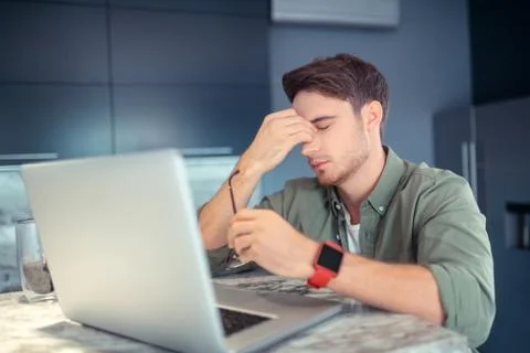 Freelancer feeling sleepy while working all day at home Foto stock