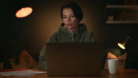 Freelancer finishes work and get up from the table, girl works from home Stock Footage 147247105