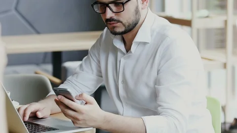 Freelancer in formal clothes sitting in cafe with personal computer and using Stock Footage 112986997
