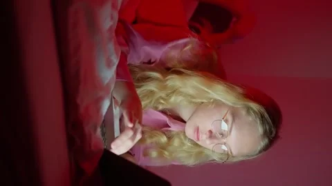Freelancer girl, lying in bed, working on a laptop. A Woman Hacker in glasses Stock Footage 258764210
