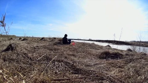 Freelancer girl using laptop, working isolation during quarantine on river shore Stock Footage 75686368