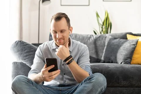 A freelancer guy is using smartphone at home Stock Photos