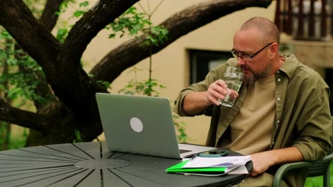 Freelancer guy working remotely in a home office outdoors. Stock Footage 243618058
