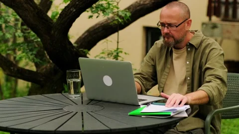 Freelancer guy working remotely in a home office outdoors. Stock Footage 245326267