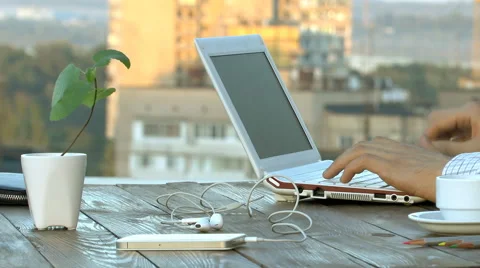 Freelancer hands typing on a keyboard  background of the city Stock Footage 62067266