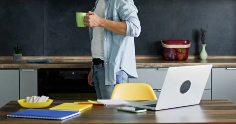 Freelancer having break drinks hot beverage and writes notes Stockbeeldmateriaal 228564845