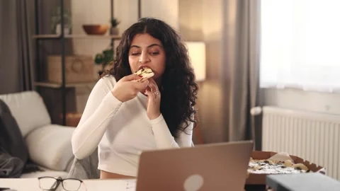 Freelancer having distance remote work and eating pizza fast food at home Stock Footage 251731716