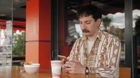 Freelancer hispanic man in cafe. Young man drinking coffee scrolling browsing Stock Footage 277201424