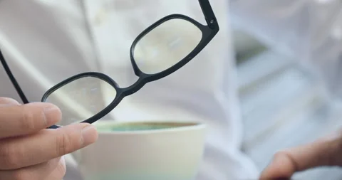 Freelancer holding glasses types messages for clients Stockbeeldmateriaal 253624665