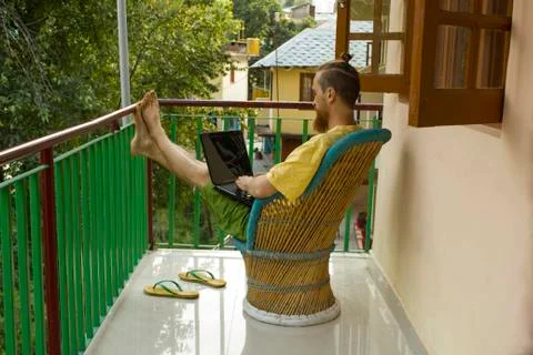 Freelancer with laptop on the balcony working Stock Photos