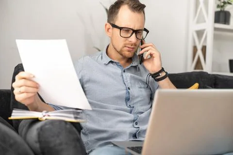 A freelancer with a laptop doing paperwork Stock Photos
