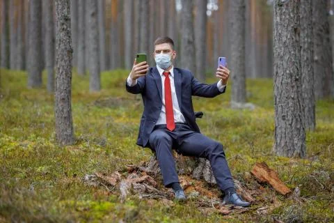 Freelancer with laptop working in forest Stock Photos