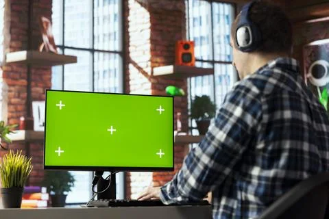 Freelancer listening music, analyzing data on isolated screen PC monitor at desk Stock Photos