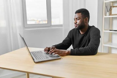 Freelancer man online office using american computer job laptop african student Stock Photos