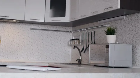 A freelancer man starts his work day from home, sits at a table and opens a Stock Footage 127606877